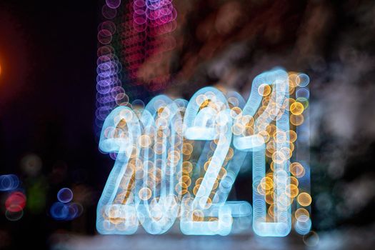 New Year Christmas decoration 2021. Numbers backlit beautiful bokeh in blur