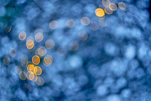 Colored lights Christmas garlands. Colorful abstract background. Blur and bokeh. Defocused bokeh lights