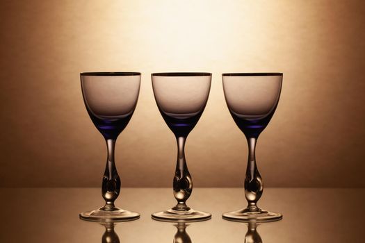 Empty wine glasses on a clean gradient background. Empty drinking transparent wine glasses