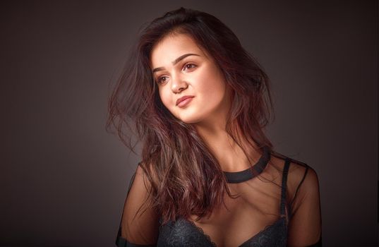 fashionable young woman in studio on dark background