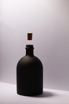 Luxury Black Glass of Rum on the white background. Levitating cork stopper.