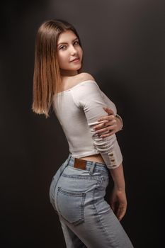 Beautiful young woman portrait, Smiling cute girl with long hair on dark background in a studio