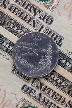 A quarter of Oregon on US dollar bills. Symmetric composition of US dollar bills and a quarter of Oregon.