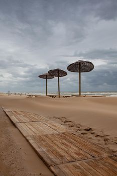 The sand-covered tables on the beach in Egmont aan Zee, Netherlands. The beach without foreign tourists after the coronavirus pandemic.