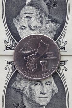 A quarter of Guam on US dollar bills. Symmetric composition of US dollar bills and a quarter of Guam