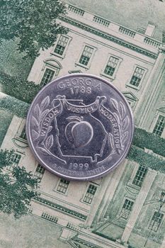 A quarter of Georgia on US dollar bills. Symmetric composition of US dollar bills and a quarter of Georgia.