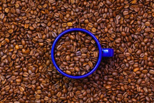 Blue tin mug full of coffee beans. Fair Trade. Commodity trade. Fresh coffee beans.
