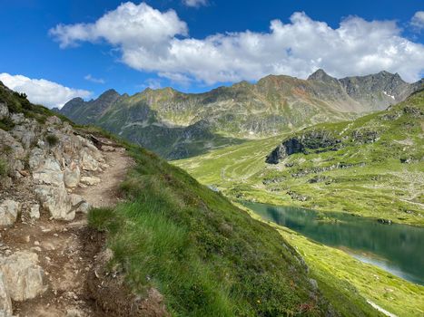 Steep footpath on the shore of the Lake Giglachsee in the Styrian Tauern - Austria. Lake Giglachsee in the Styrian Tauern - Austria. The place without  tourists after the coronavirus pandemic.