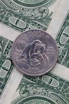 A quarter of Alaska on US dollar bills. Symmetric composition of US dollar bills and a quarter of Alaska.