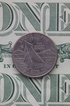 A quarter of Rhode Island on US dollar bills. Symmetric composition of US dollar bills and a quarter of Rhode Island