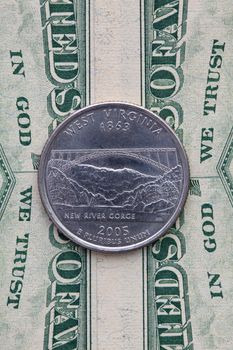 A quarter of West Virginia on US dollar bills. Symmetric composition of US dollar bills and a quarter of West Virginia