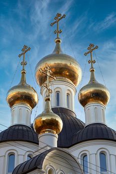 Golden domes and crosses of the Christian church against the blue sky. close-up