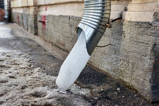 Frozen water in a downspout creates drainage problems. Frozen water in a downspout creates drainage problems