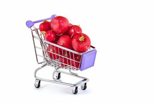 Red ripe red-haired lies in a small supermarket trolley on a white background, close up