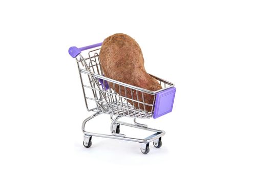potatoes lies in small supermarket trolley on white background, close up