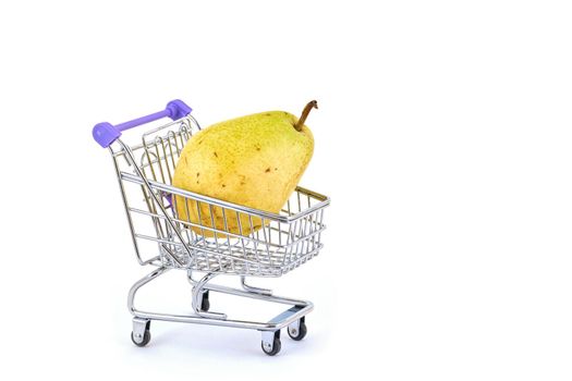 Beautiful ripe pear lies in a shopping cart isolated on a white background. Conceptual image