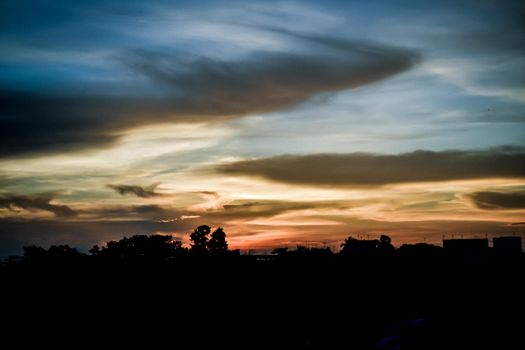 Sunset sky background. Multi color clouds-cape in sunset sky at dusk. Dramatic atmospheric mood. Landscape Beauty in nature horizon.