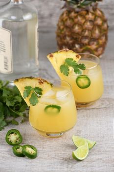  Tequila cocktail with pineapple juice, jalapeno  slices and cilantro, cooled with ice