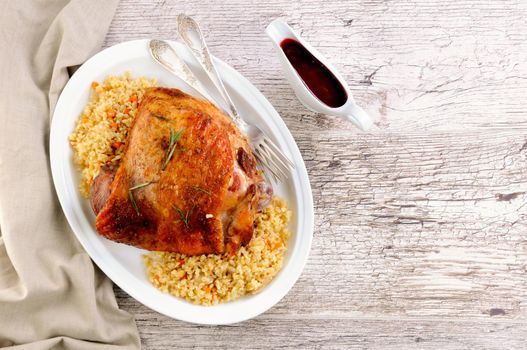 Baked turkey thigh with garnish bulgur and vegetables
