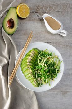 Chukka salad, cucumber noodles with avocado and peanut brown sauce in sauceboat