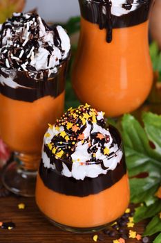 Pumpkin chocolate beverage with whipped cream and chocolate topping