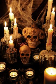 Still life from  skulls on the book next to the environment of candles. concept of black magic. Halloween.