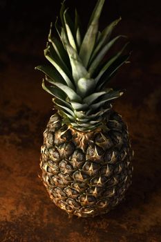 Pine Apple Whole Tropical Fruits with Leaves rusty background Useful Natural Organic Food Style. Close-up.