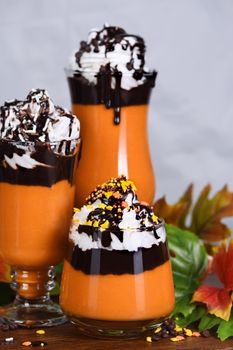 Pumpkin chocolate beverage with whipped cream and chocolate topping