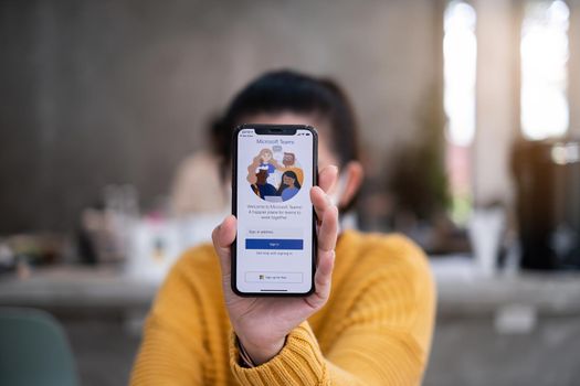 CHIANG MAI, THAILAND - APR 14, 2021 : A working from home employee is downloading the Microsoft Teams social platform