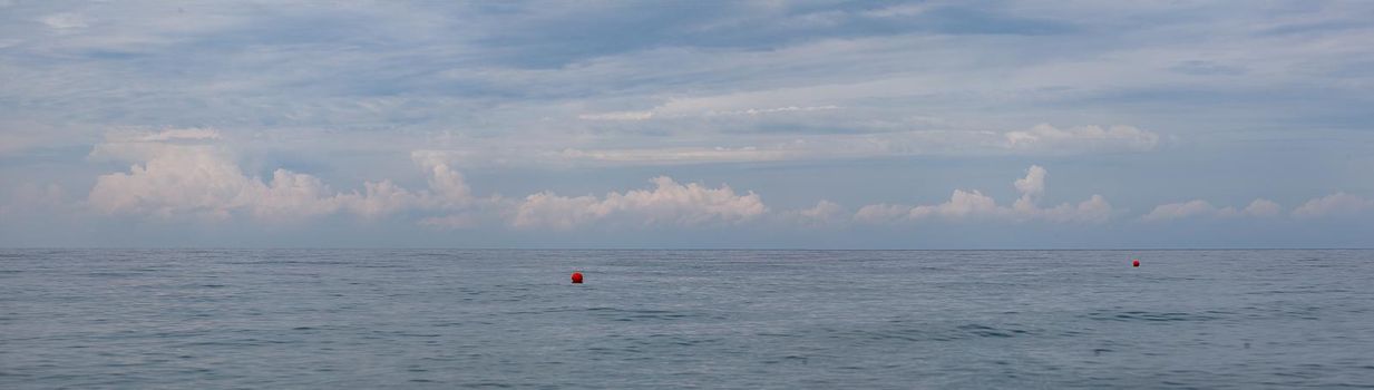 Morning seascape with clouds and buoys