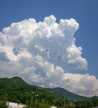 Landscape wtih big white cloud above mountains