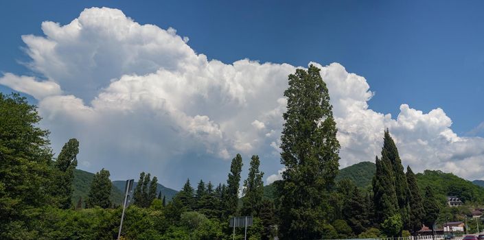 Landscape wtih big white cloud above mountains