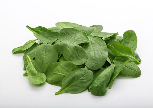 Mound of fresh green spinach in the white background