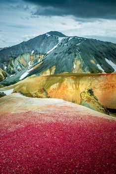 Colorful rainbow volcanic Landmannalaugar mountains at famous Laugavegur hiking trail, with dramatic sky view and snow in Iceland, summer