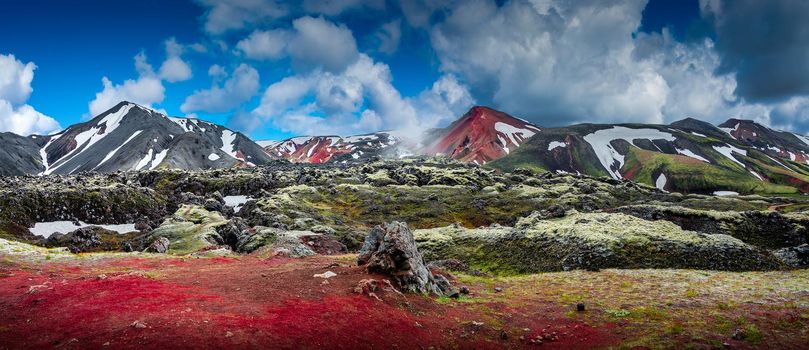 Panoramic landscape view of colorful rainbow volcanic Landmannalaugar mountains and hiking trail path at dramatic sky in Iceland, summer