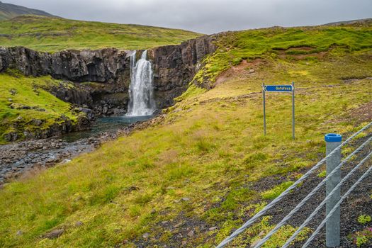 Lonely waterfall called Gufufoss near the road with a sign spelt its name at East Iceland