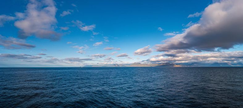 Panoramic view over mythical Faroe Islands in the middle of Atlantic Ocean with a lot of wild sea life, blue sky, sunny day