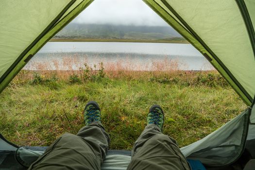 Looking at the nature from a tent in wild, while hiking in Iceland, summer, scenic view