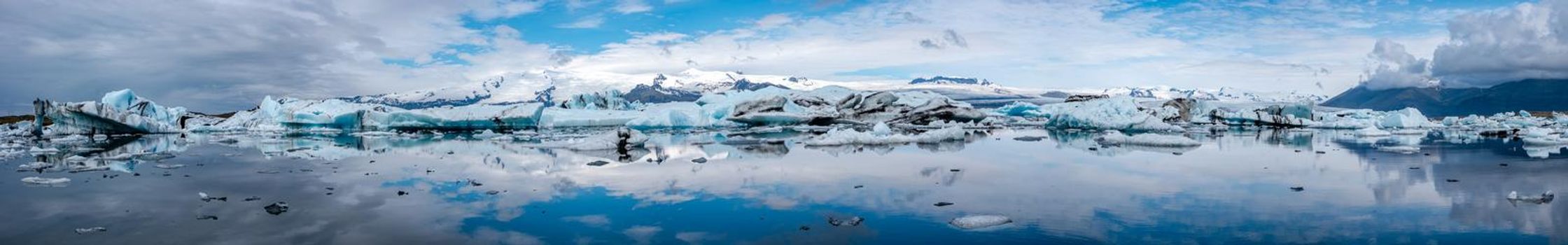 Panoramic view of Glacier Lagoon Jokulsarlon with icebergs and Vatnajokull Glacier tongue, Iceland