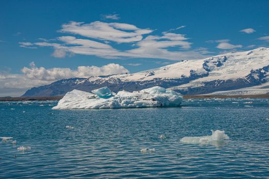 View of Glacier Lagoon Jokulsarlon with icebergs and Vatnajokull Glacier tongue, Iceland