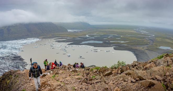 Panoramic view over Skaftafellsjokull glacier and tourists, a wander near Skaftafell on South Iceland