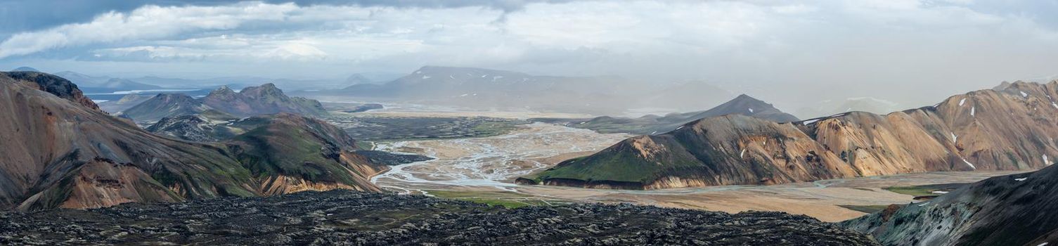 Before storm, panoramic view over iconic colorful rainbow volcanic mountains Landmannalaugar, Laugahraun lava field and camping site in Iceland, summer