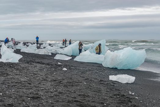 Touristic activity in Glacier Lagoon Jokulsarlon with icebergs in Iceland