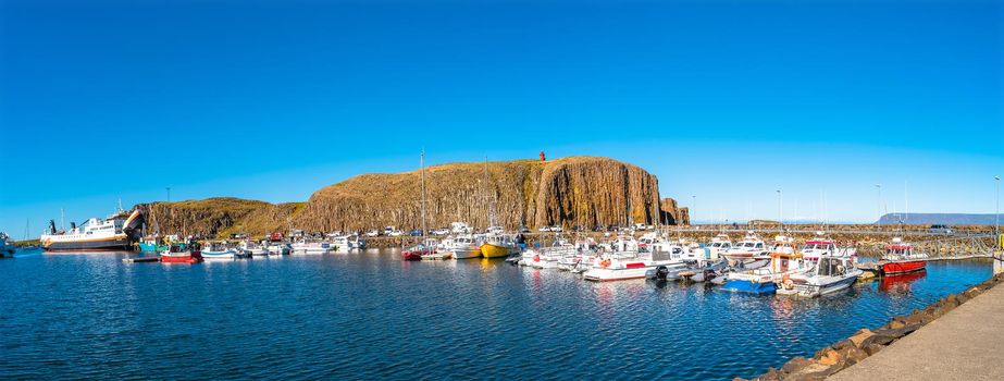 Panoramic view over Stykkisholmur (Stykkish) downtown and harbor with many fish restaurants, yachts, boats and a ferryboat towards Western Fjords, Iceland