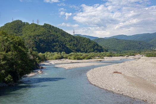 Summer landscape with mountain river in the forested mountains