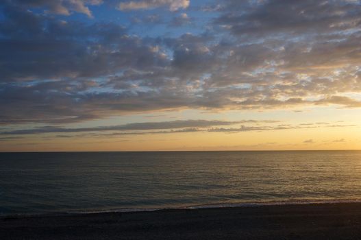 Landscape with sunset and clouds on the sea coast