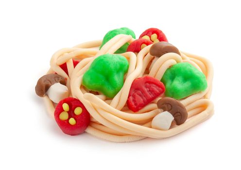 Isolated plasticine pasta with vegetables on the white