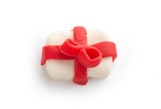 Isolated plasticine gift with red ribbon on the white