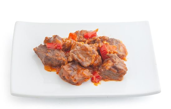 Isolated beef paprikash on the white plate
