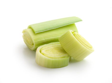 Isolated pieces of fresh green leek on the white background